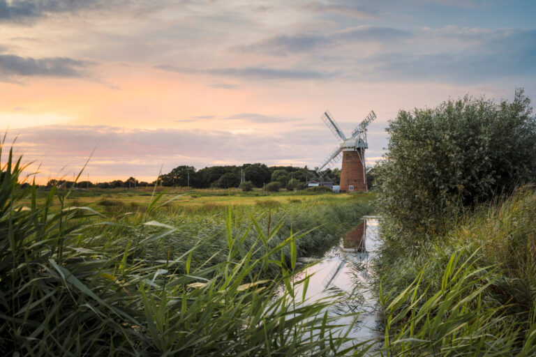 Sunset over Horsey Mill on the Norfolk Broads on a summers evening